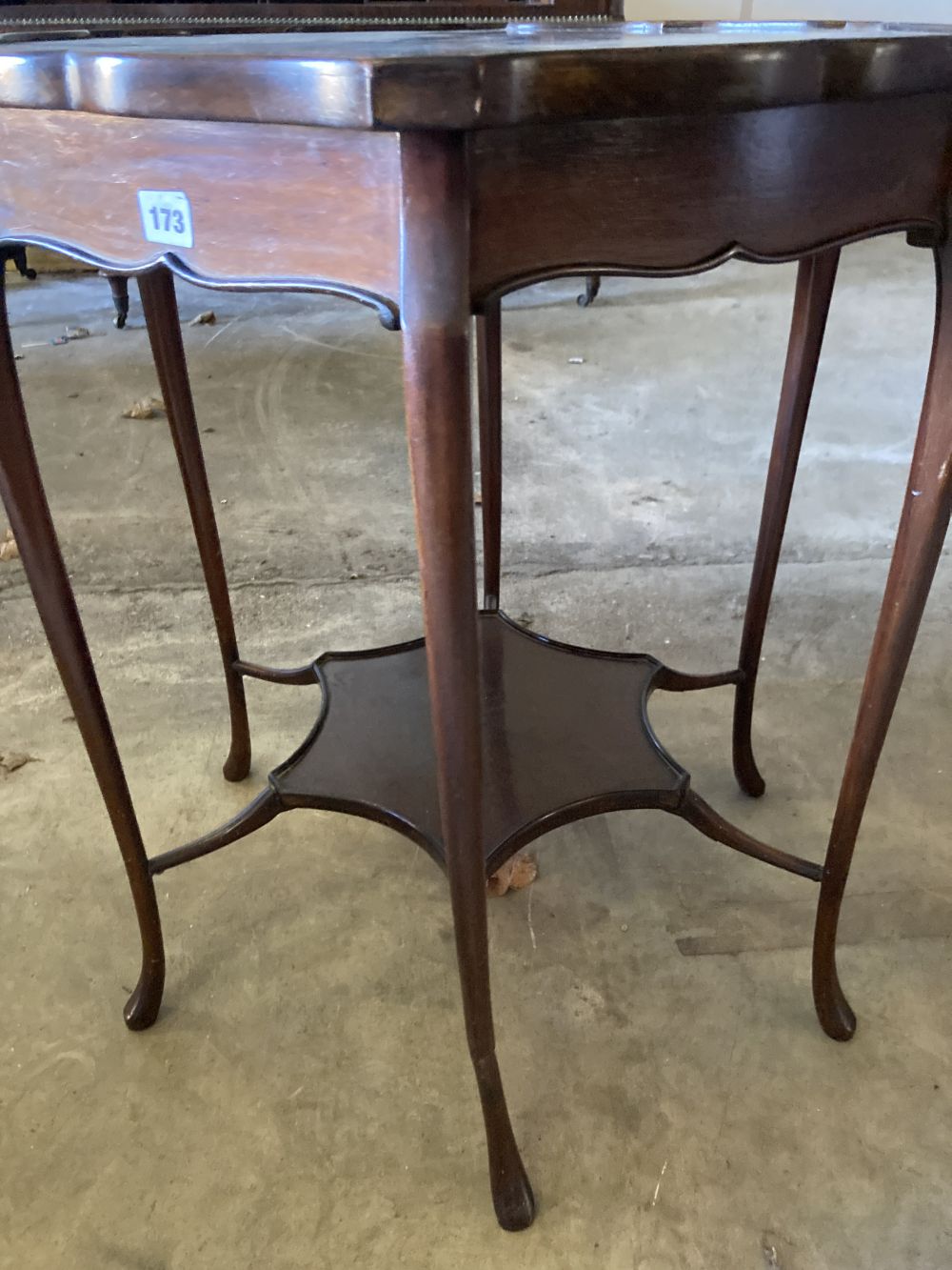 A late Victorian mahogany shaped circular topped two tier table, 67cm diameter, 72cm high